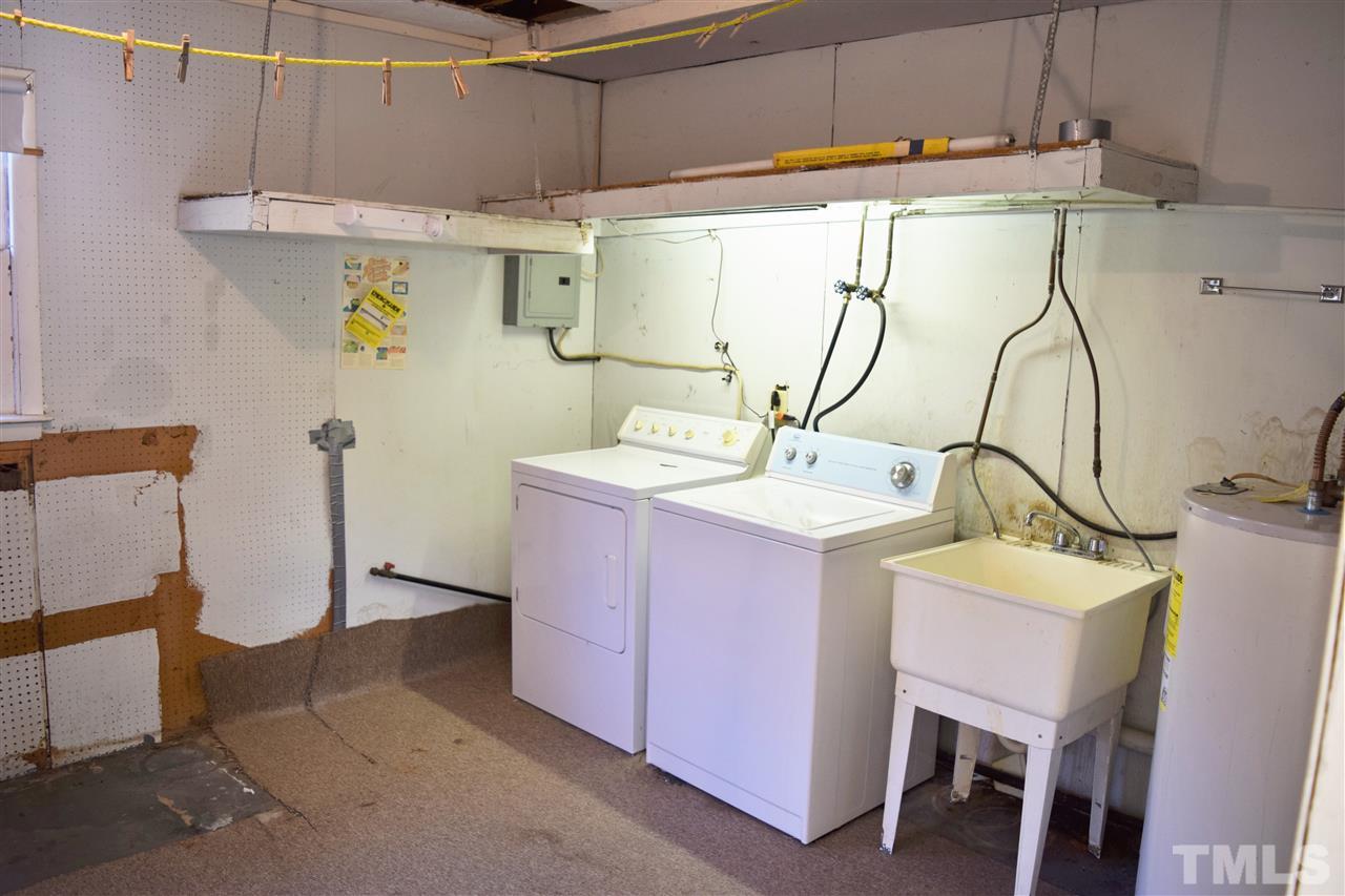 405 Winterlochen Road Raleigh, NC 27603 - Photo 11 of 25 a bathroom with a sink mirror and vanity