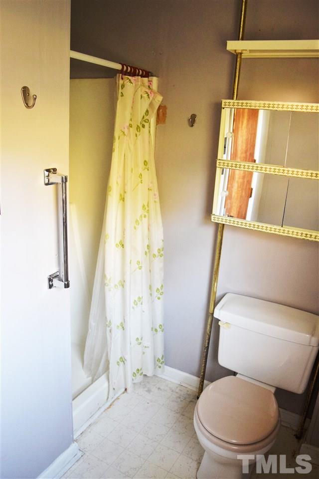 405 Winterlochen Road Raleigh, NC 27603 - Photo 12 of 25 a bathroom with a toilet and a shower