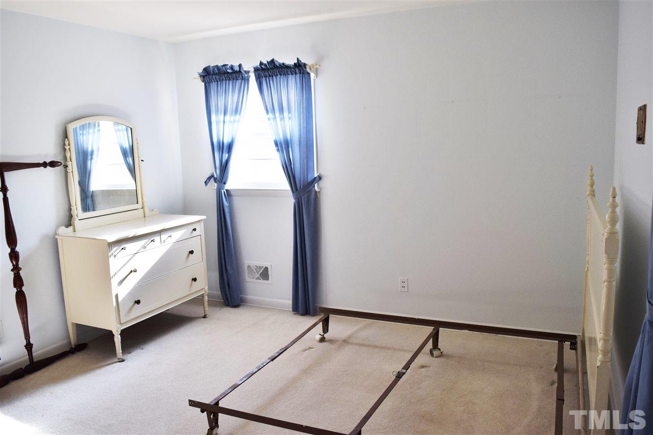 405 Winterlochen Road Raleigh, NC 27603 - Photo 14 of 25 a room with a mirror and a dresser