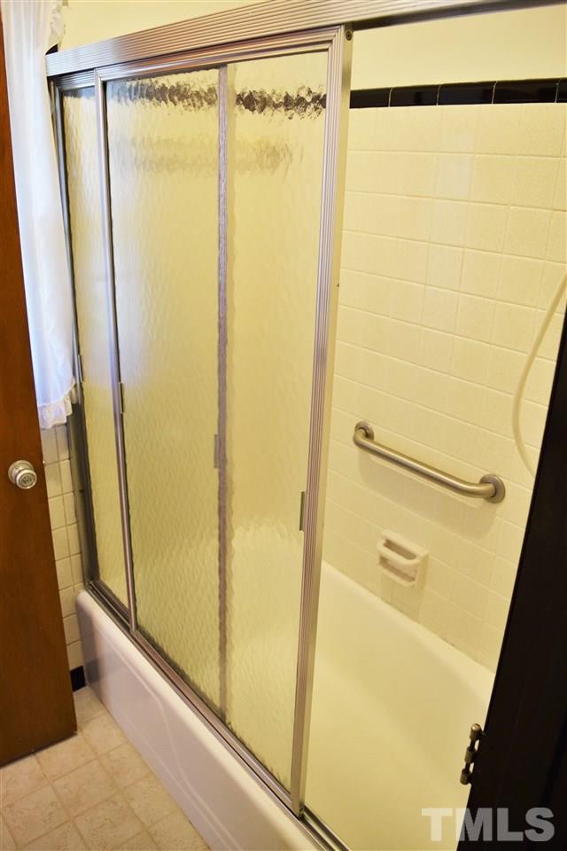 405 Winterlochen Road Raleigh, NC 27603 - Photo 17 of 25 a bathroom with a glass door