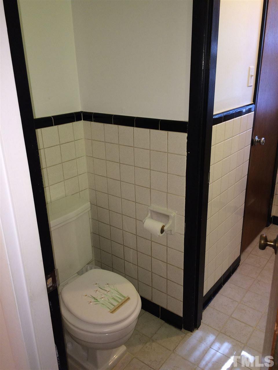 405 Winterlochen Road Raleigh, NC 27603 - Photo 18 of 25 a bathroom with a toilet and a shower