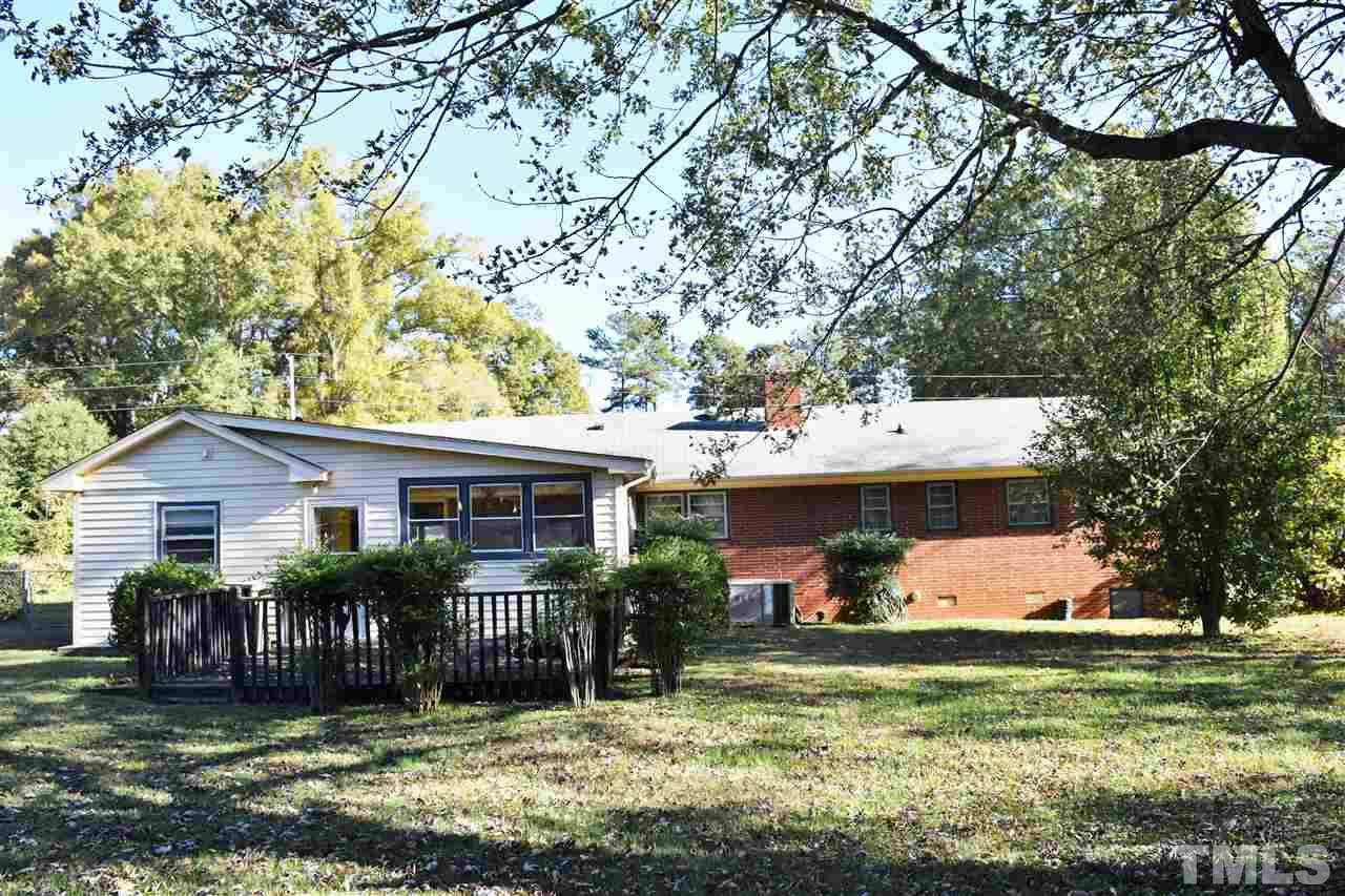 405 Winterlochen Road Raleigh, NC 27603 - Photo 24 of 25 a view of a house with backyard and a tree