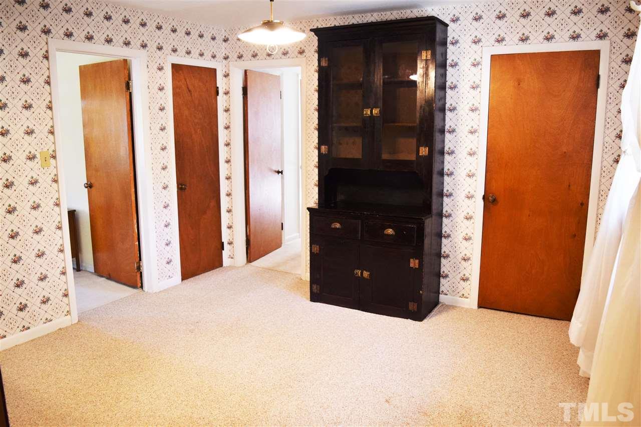 405 Winterlochen Road Raleigh, NC 27603 - Photo 4 of 25 a bedroom with a bed and a dresser
