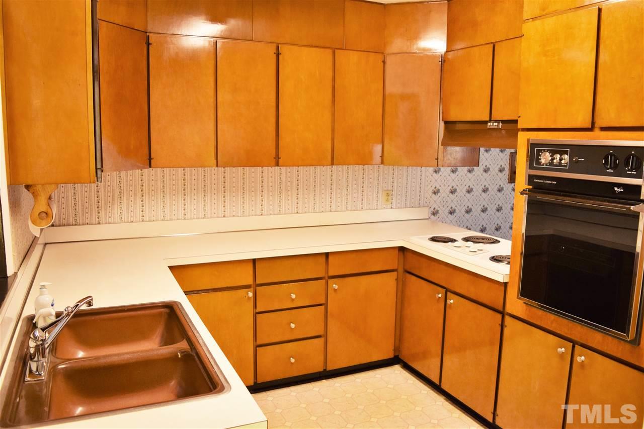405 Winterlochen Road Raleigh, NC 27603 - Photo 5 of 25 a kitchen with a sink and a stove top oven