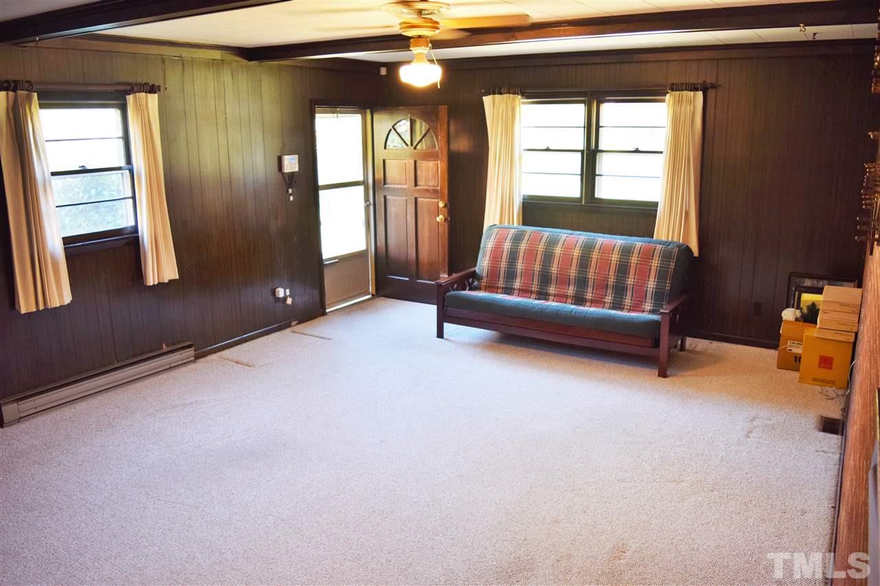 405 Winterlochen Road Raleigh, NC 27603 - Photo 7 of 25 a living room with furniture and a window