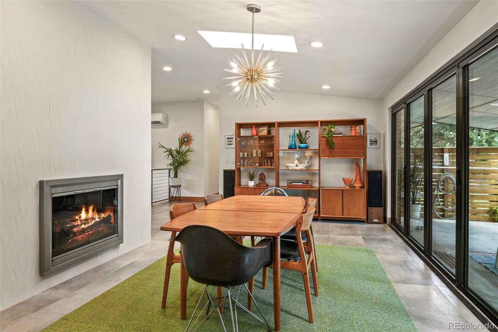 14010 Braun Road Golden, CO 80401 - Photo 14 of 49 a dining room with furniture a fireplace and wooden floor