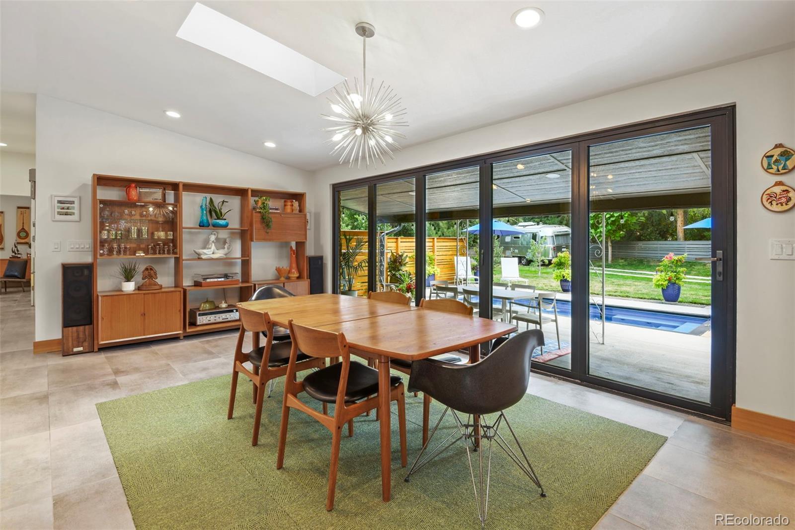 14010 Braun Road Golden, CO 80401 - Photo 15 of 49 a dining room with furniture a chandelier and wooden floor