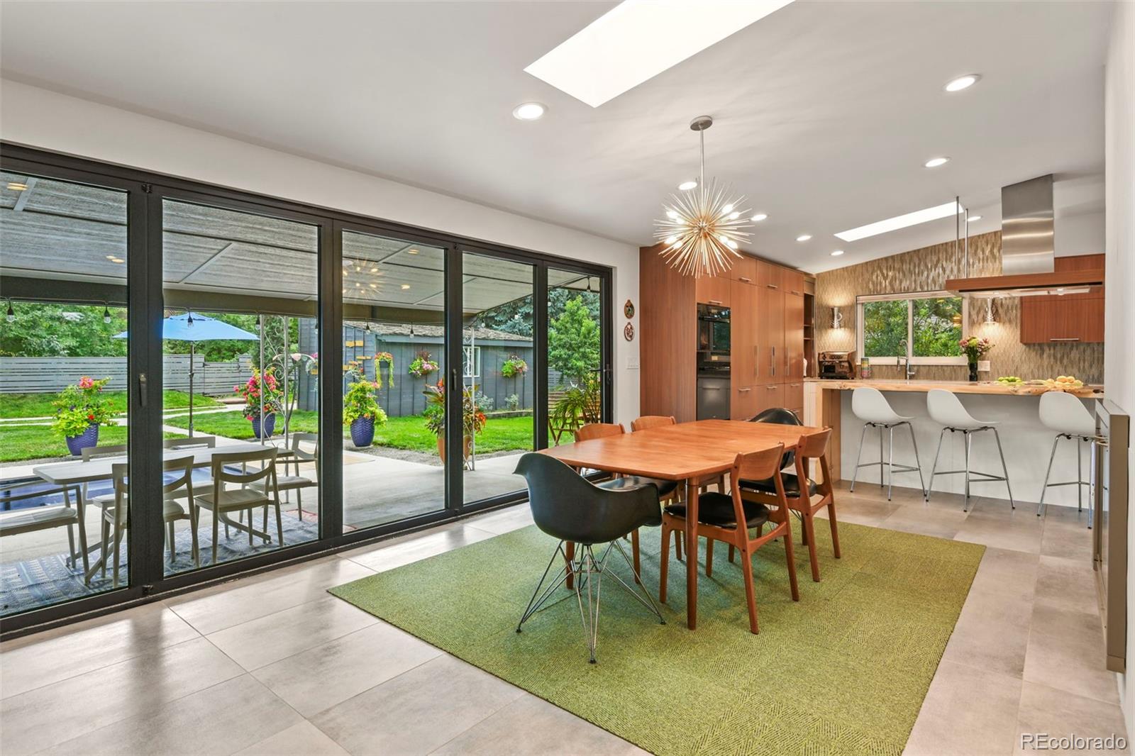 14010 Braun Road Golden, CO 80401 - Photo 17 of 49 a dining room with glass top table and chairs