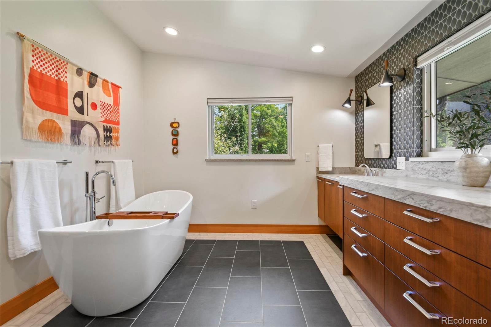 14010 Braun Road Golden, CO 80401 - Photo 25 of 49 a bathroom with a granite countertop sink and a bathtub