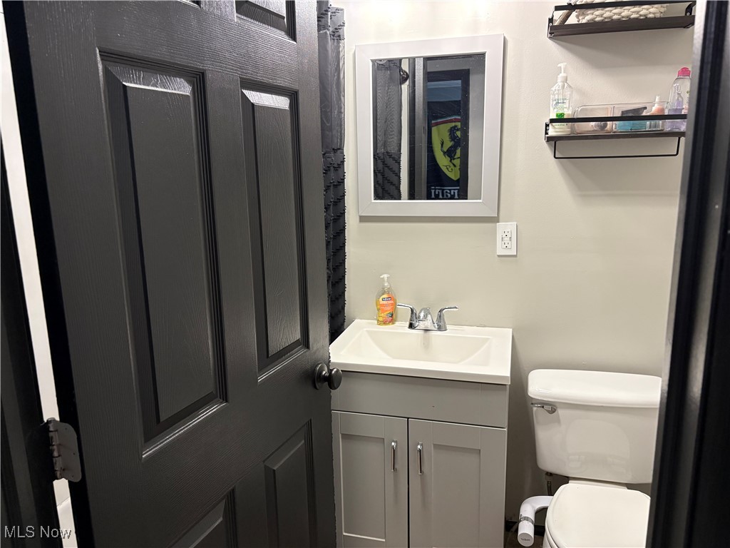 678 High Bridge Road Vermilion, OH 44089 - Photo 2 of 8 Half bathroom featuring toilet and vanity