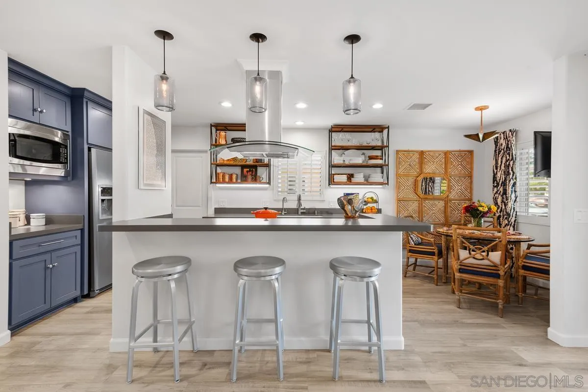763 Snapdragon Street Encinitas, CA 92024 - Photo 4 of 22 a large kitchen with granite countertop a counter space chairs stainless steel appliances and cabinets