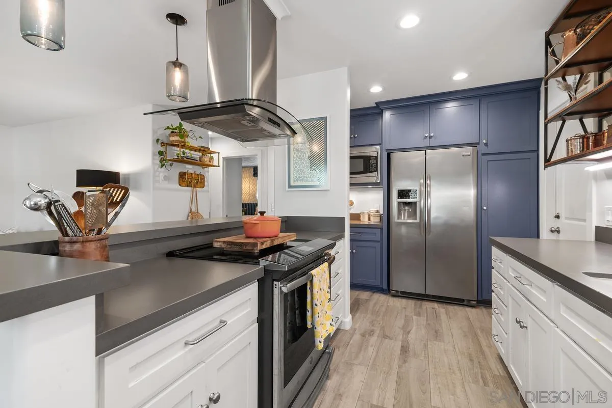 763 Snapdragon Street Encinitas, CA 92024 - Photo 6 of 22 a kitchen with stainless steel appliances granite countertop a sink a stove and a refrigerator