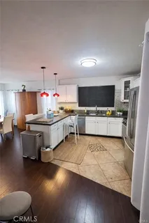 a large white room with a couch and a flat screen tv