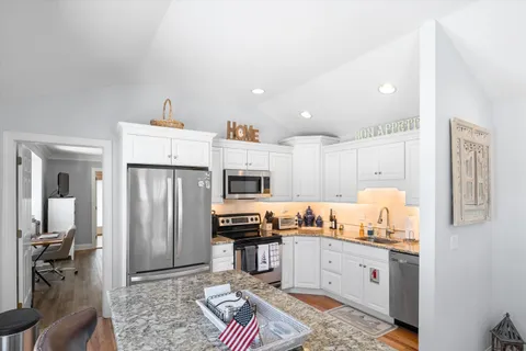 a kitchen with refrigerator and cabinets