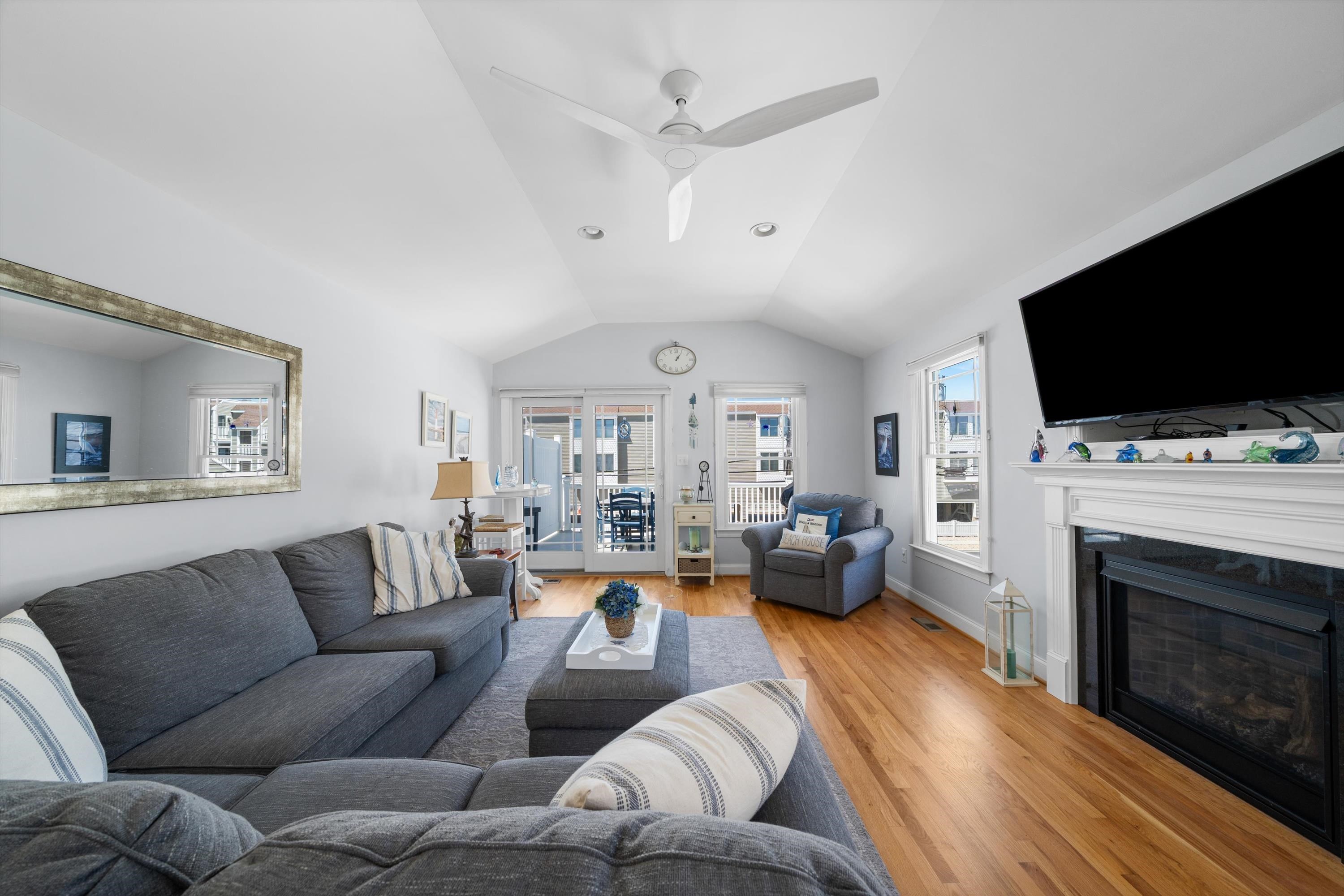 8222 3rd Avenue, Unit NORTH Stone Harbor, NJ 08247 - Photo 17 of 32 a living room with furniture a flat screen tv and a fireplace