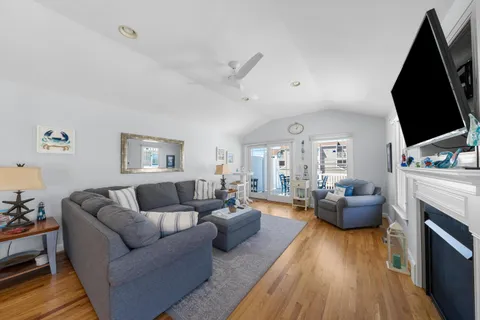 a living room with furniture fireplace and a flat screen tv
