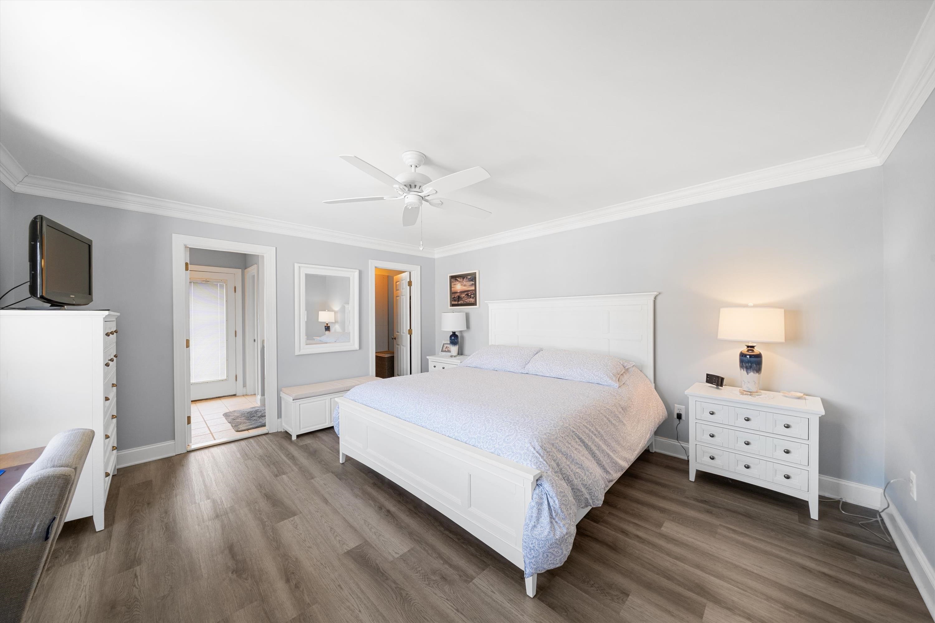 8222 3rd Avenue, Unit NORTH Stone Harbor, NJ 08247 - Photo 20 of 32 a bedroom with a bed and a chandelier