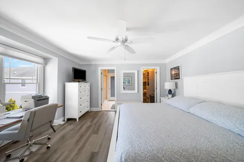 a bed room with furniture and wooden floor