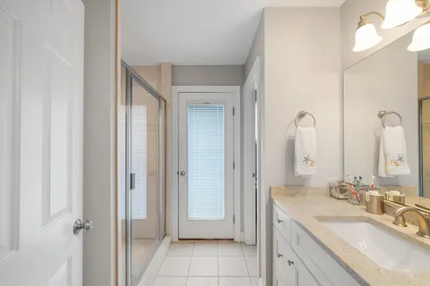 a bathroom with a double vanity sink and a mirror