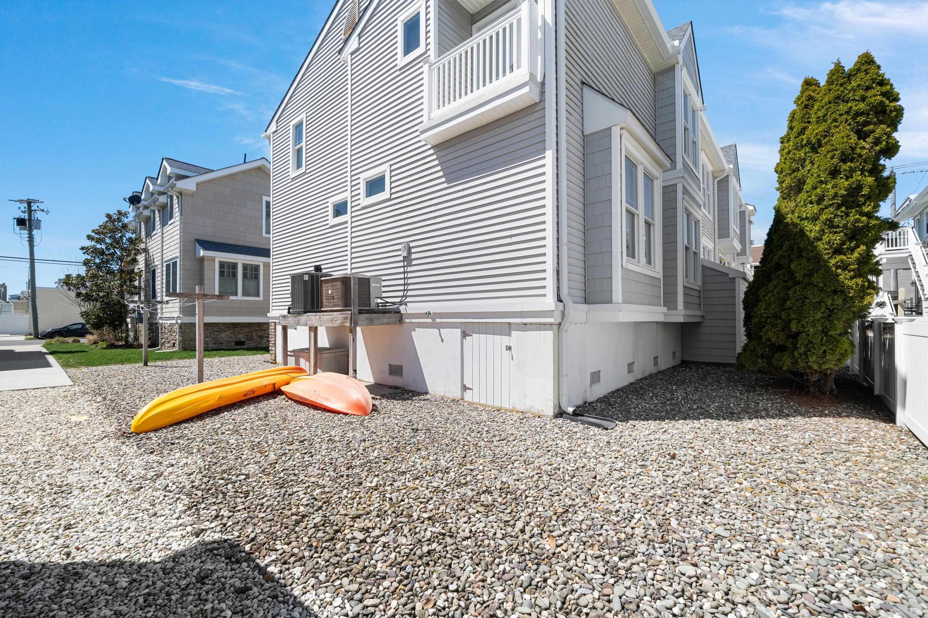 8222 3rd Avenue, Unit NORTH Stone Harbor, NJ 08247 - Photo 27 of 32 a view of a white house with a swimming pool and sitting area