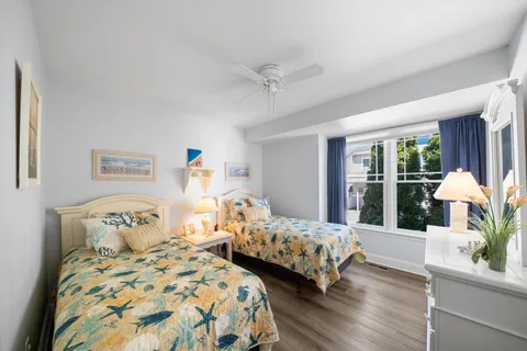 a bedroom with two beds and a large window