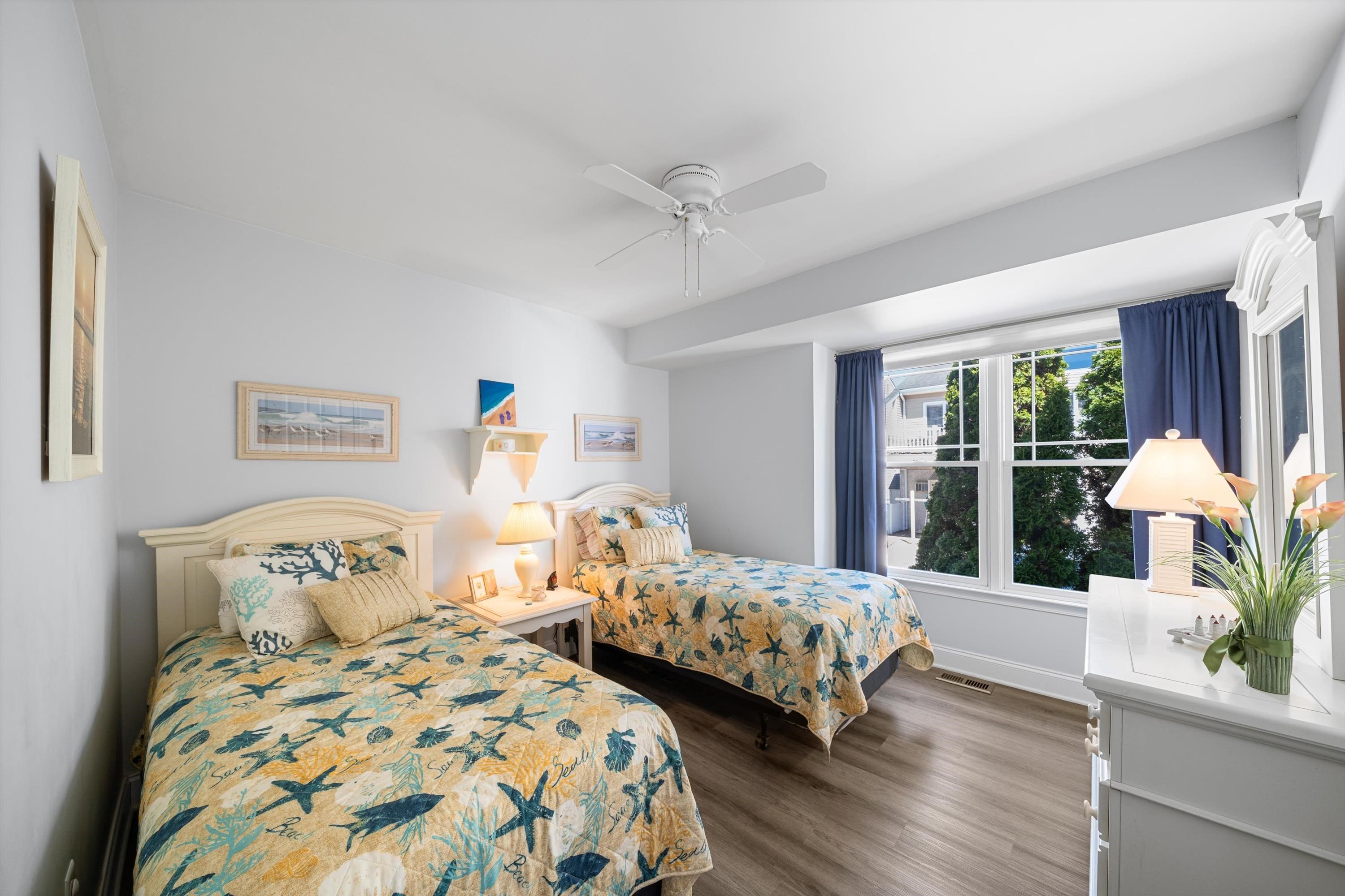 8222 3rd Avenue, Unit NORTH Stone Harbor, NJ 08247 - Photo 5 of 32 a bedroom with two beds and a large window
