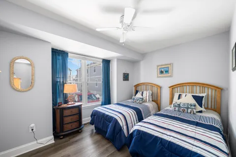 a bedroom with two beds and a chandelier