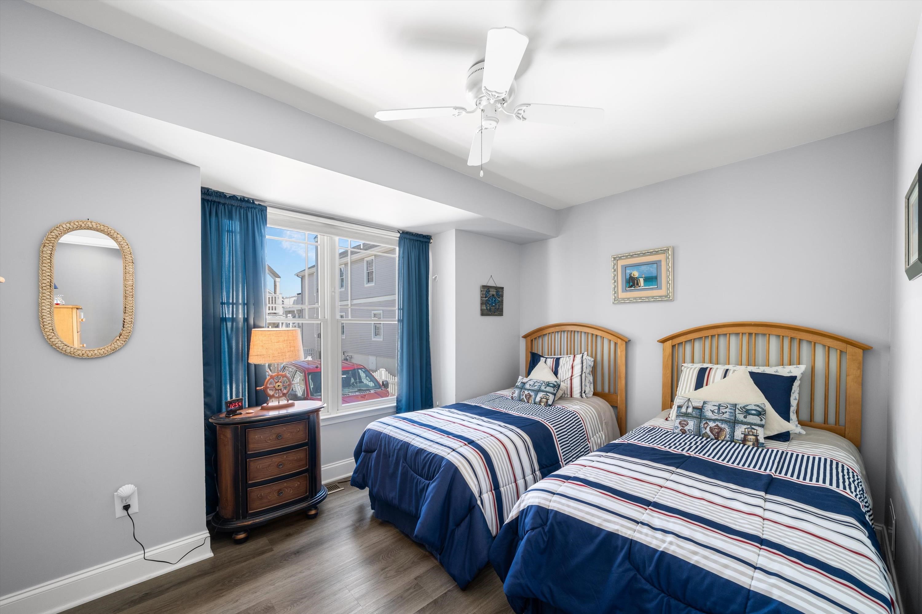 8222 3rd Avenue, Unit NORTH Stone Harbor, NJ 08247 - Photo 7 of 32 a bedroom with two beds and a chandelier