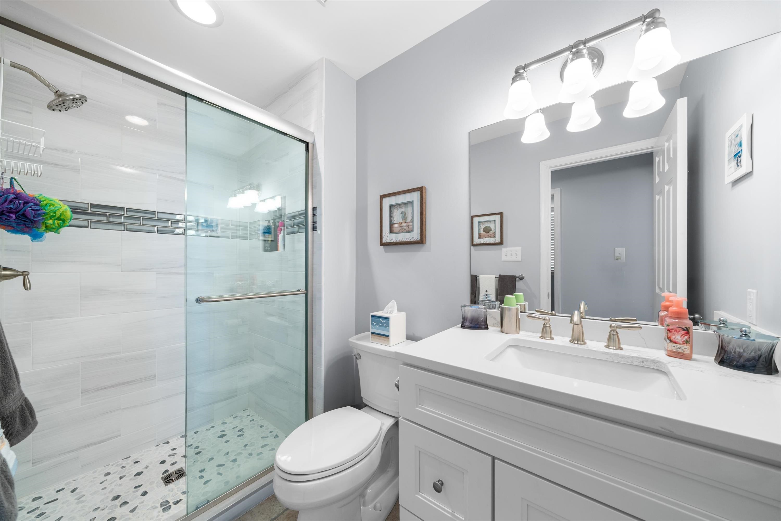 8222 3rd Avenue, Unit NORTH Stone Harbor, NJ 08247 - Photo 9 of 32 a bathroom with a sink a toilet and shower