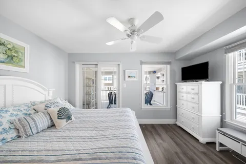 a bedroom with a large bed and a flat tv screen