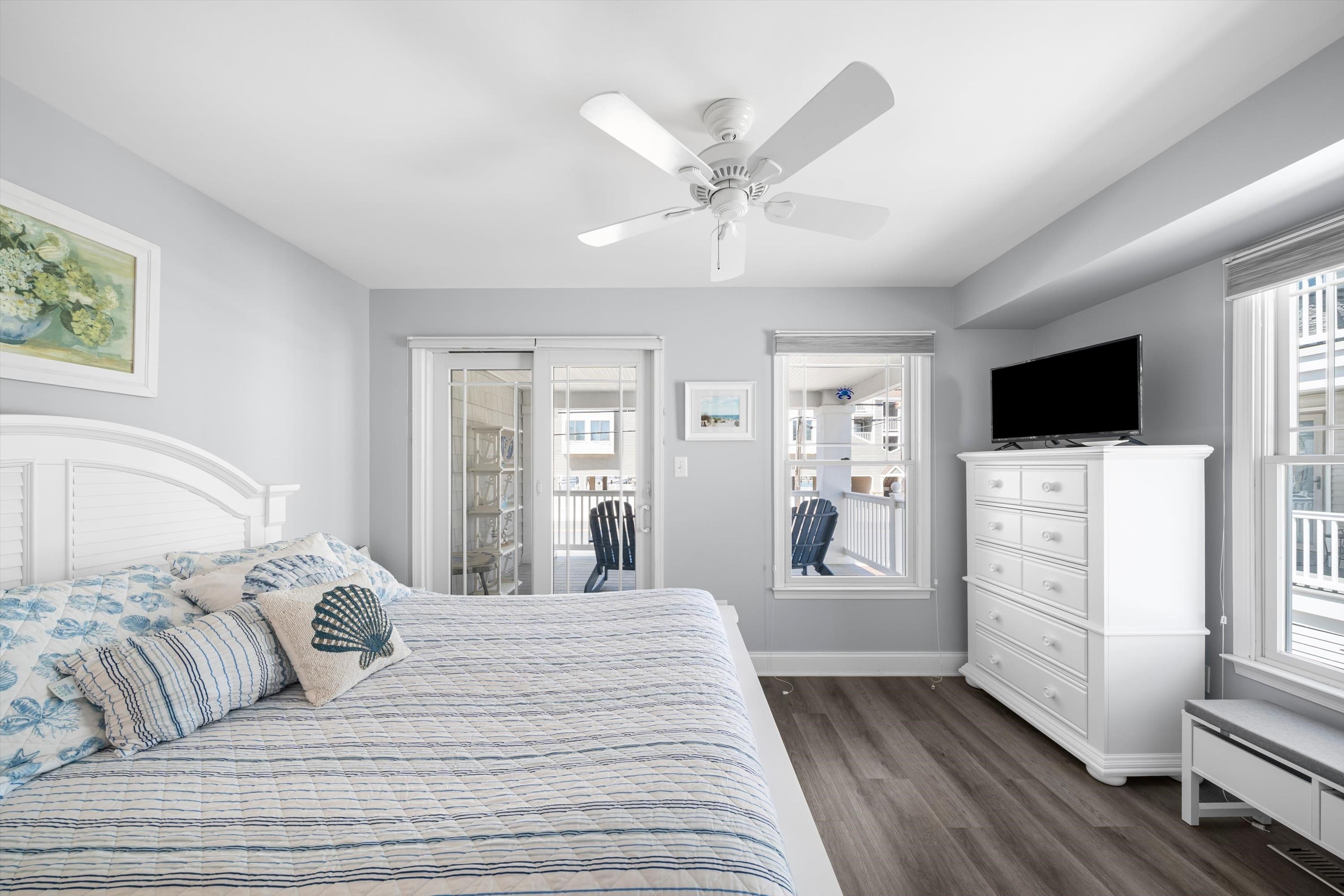 8222 3rd Avenue, Unit NORTH Stone Harbor, NJ 08247 - Photo 10 of 32 a bedroom with a large bed and a flat tv screen