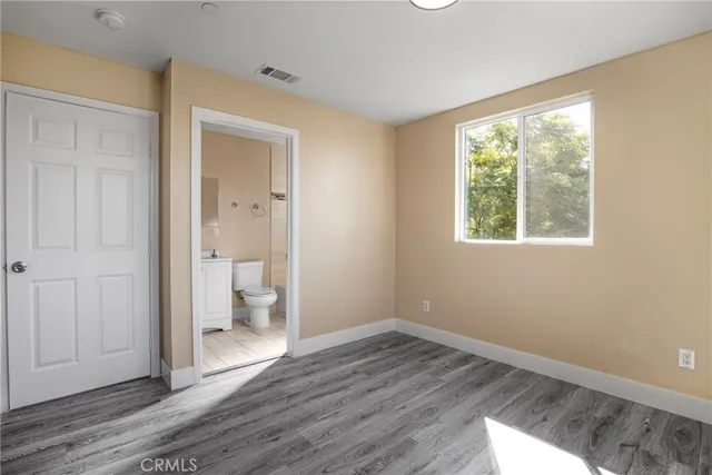 a view of a room with wooden floor and a window