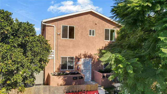 an aerial view of a house with a yard and a fountain