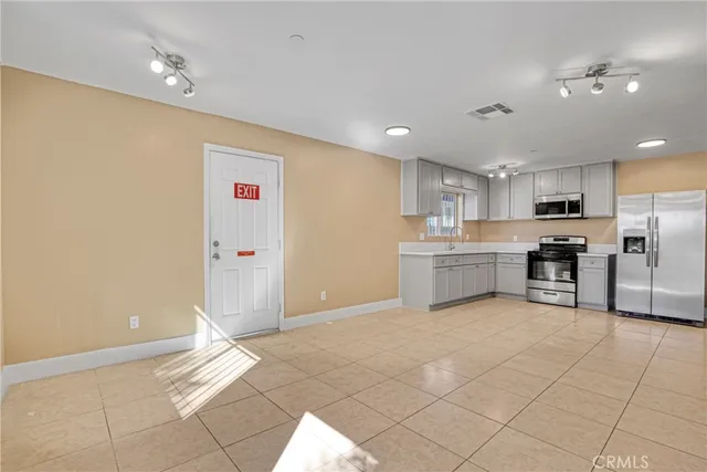 a kitchen with stainless steel appliances a refrigerator sink and cabinets