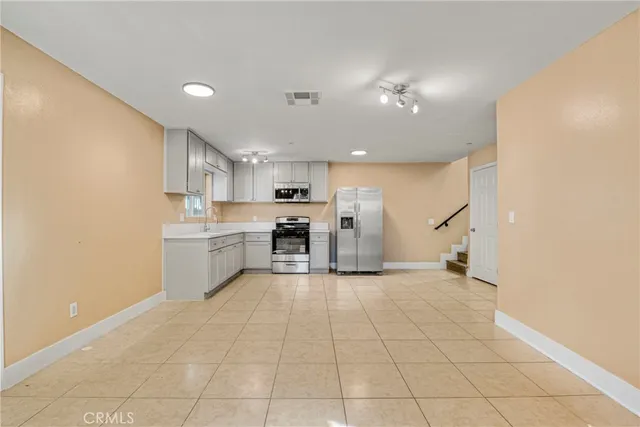 a view of a kitchen with microwave and cabinets