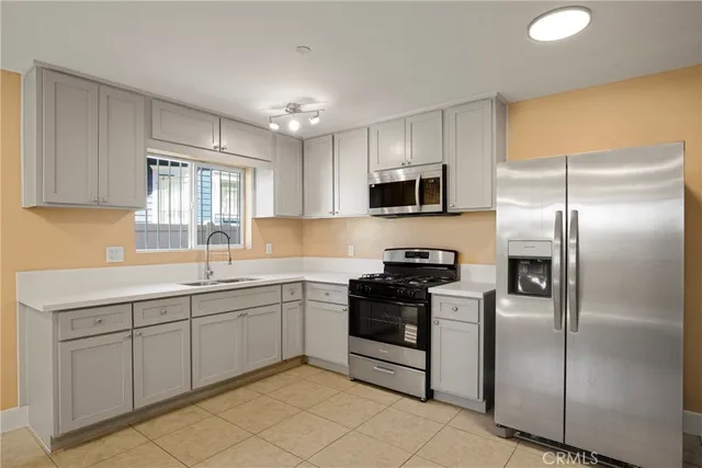 a kitchen with a sink stainless steel appliances and cabinets