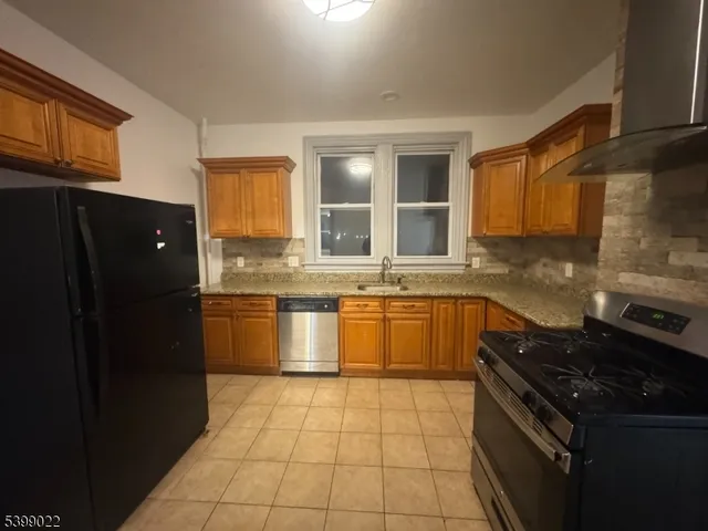 a kitchen with a stove top oven sink and cabinets