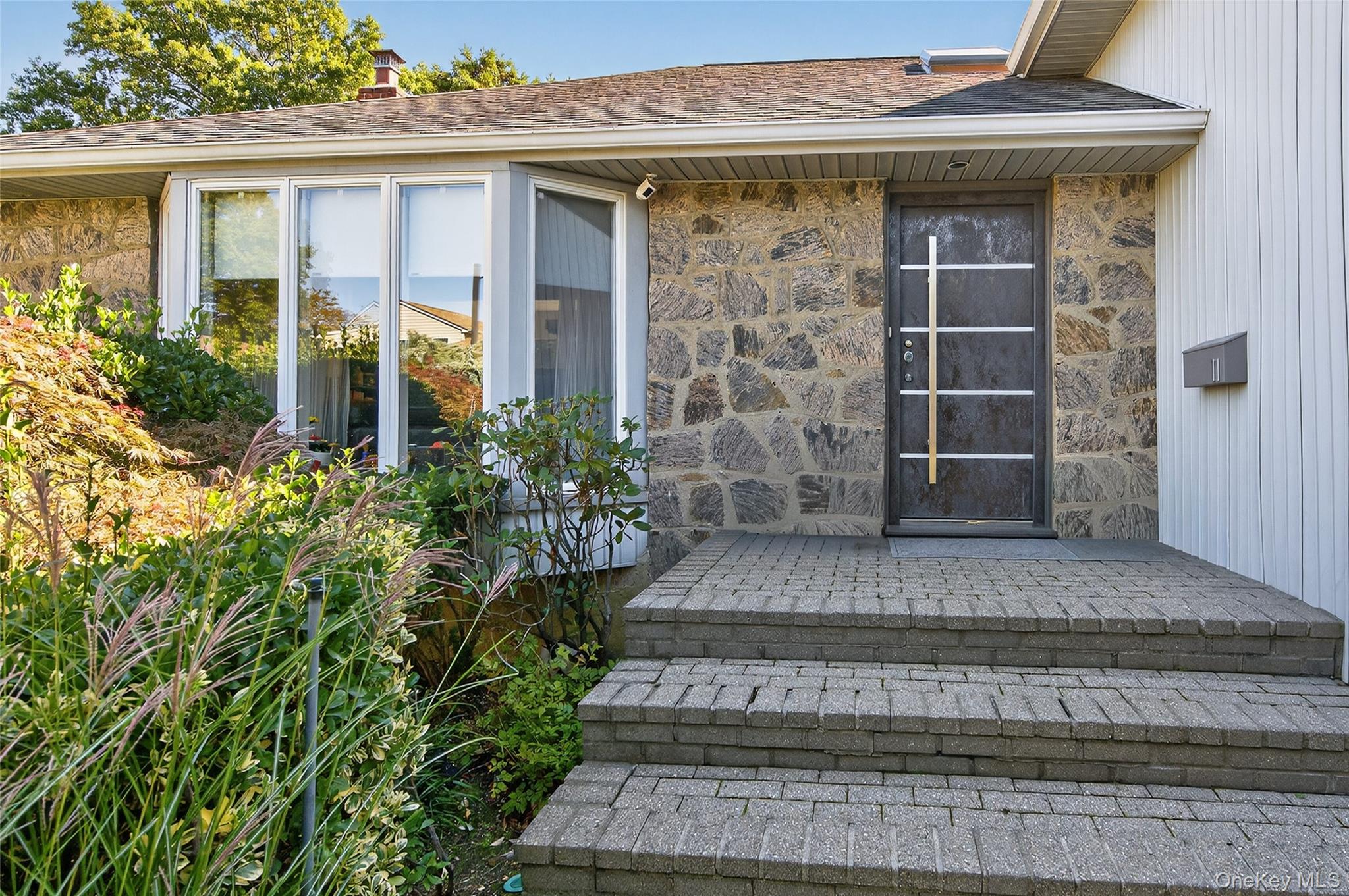 11 Sunbeam Road Syosset, NY 11791 - Photo 2 of 28 Stone facade with a custom European entry door