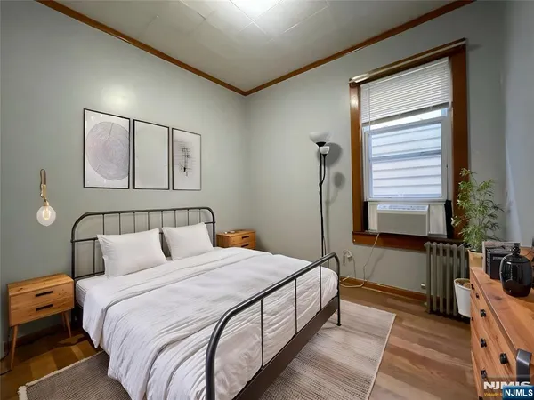 a bedroom with double bed and a window