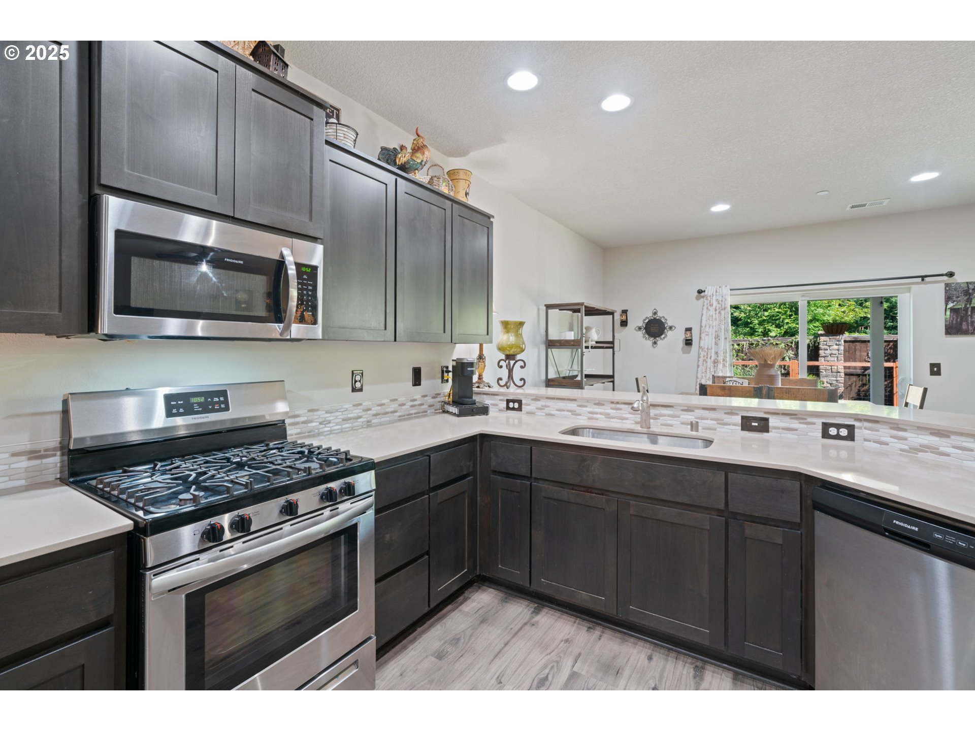 1707 Northeast 37th Avenue Camas, WA 98607 - Photo 11 of 44 a kitchen with stainless steel appliances a sink stove and cabinets