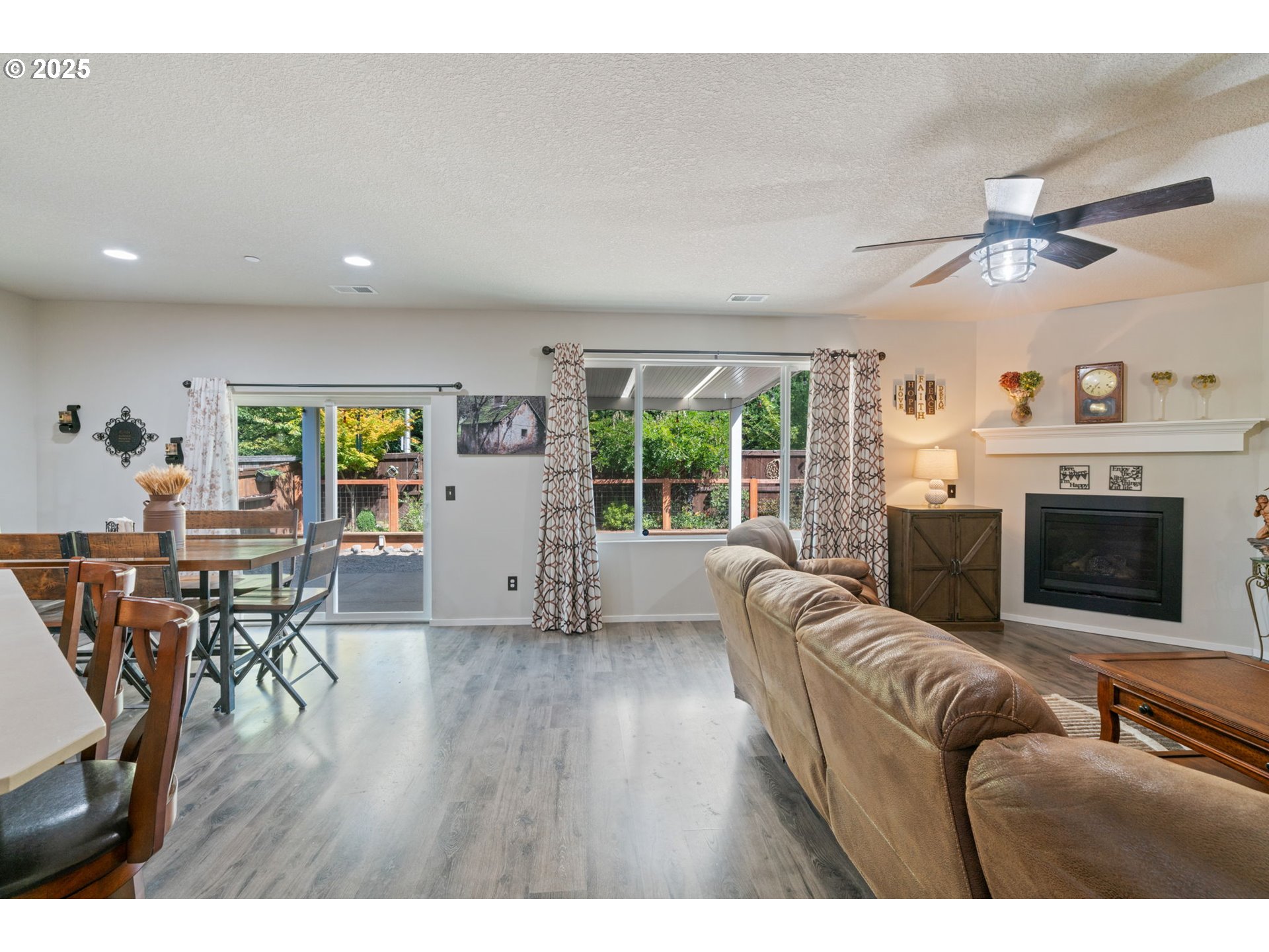 1707 Northeast 37th Avenue Camas, WA 98607 - Photo 18 of 44 a living room with furniture a fireplace and wooden floor