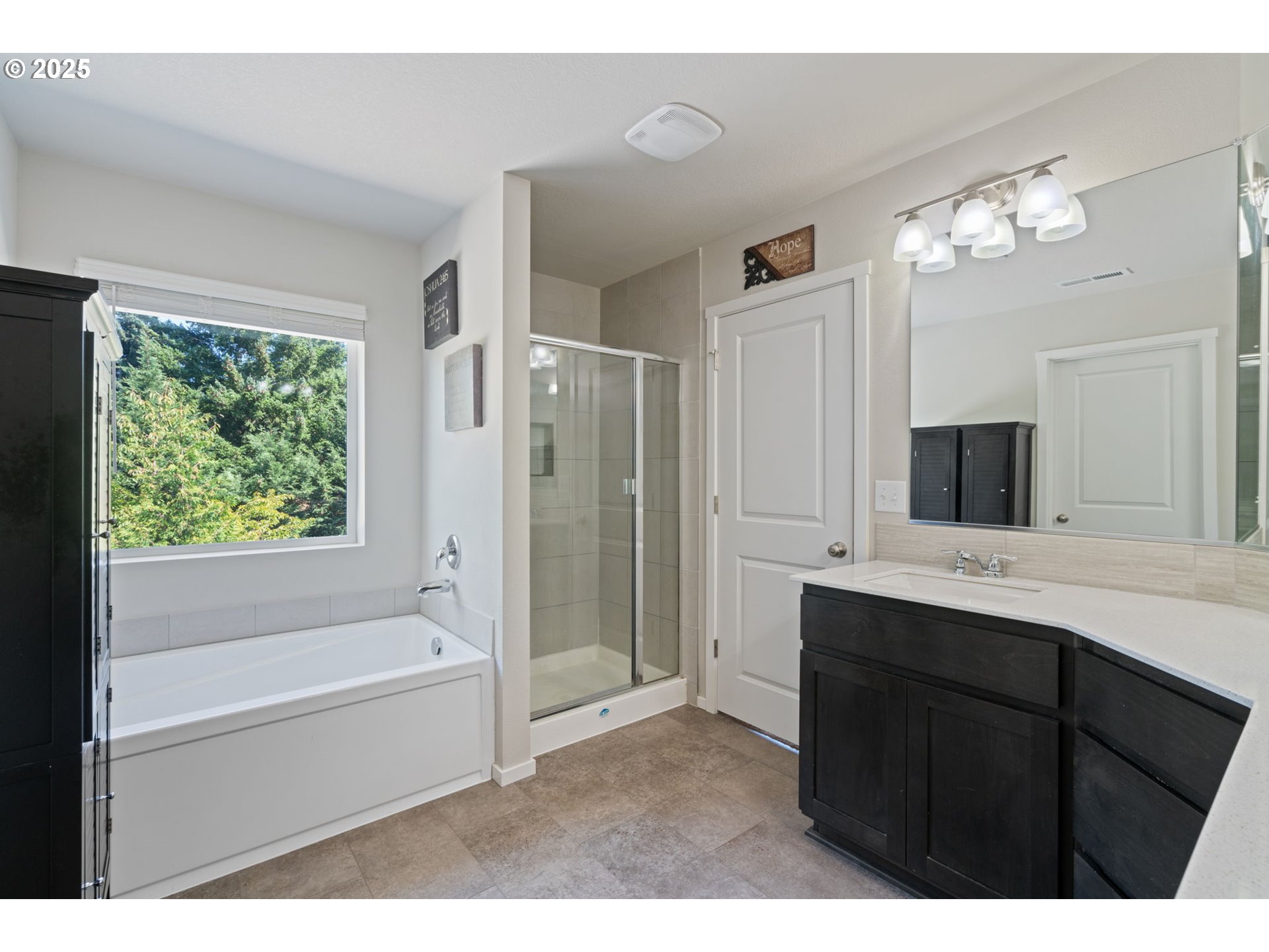 1707 Northeast 37th Avenue Camas, WA 98607 - Photo 27 of 44 a bathroom with a tub a sink double vanity and a mirror