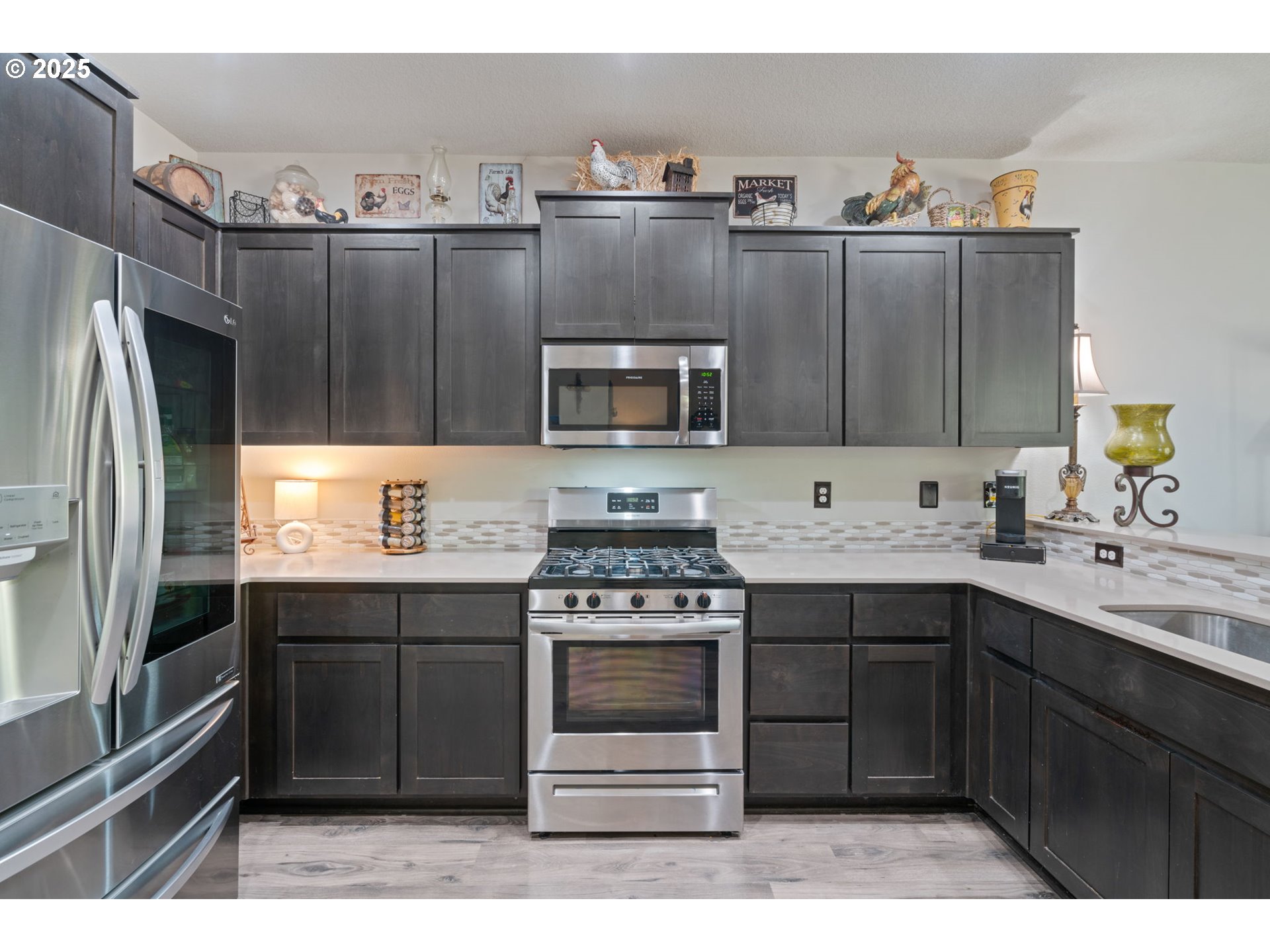 1707 Northeast 37th Avenue Camas, WA 98607 - Photo 10 of 44 a kitchen with granite countertop a stove and a refrigerator