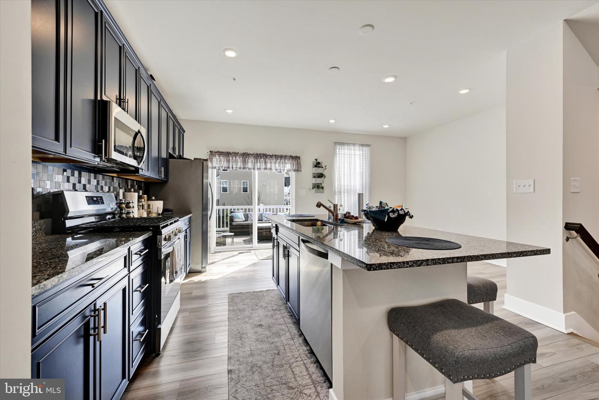 1819 Betterton Road Essex, MD 21221 - Photo 12 of 27 a kitchen with stainless steel appliances granite countertop a sink stove and refrigerator
