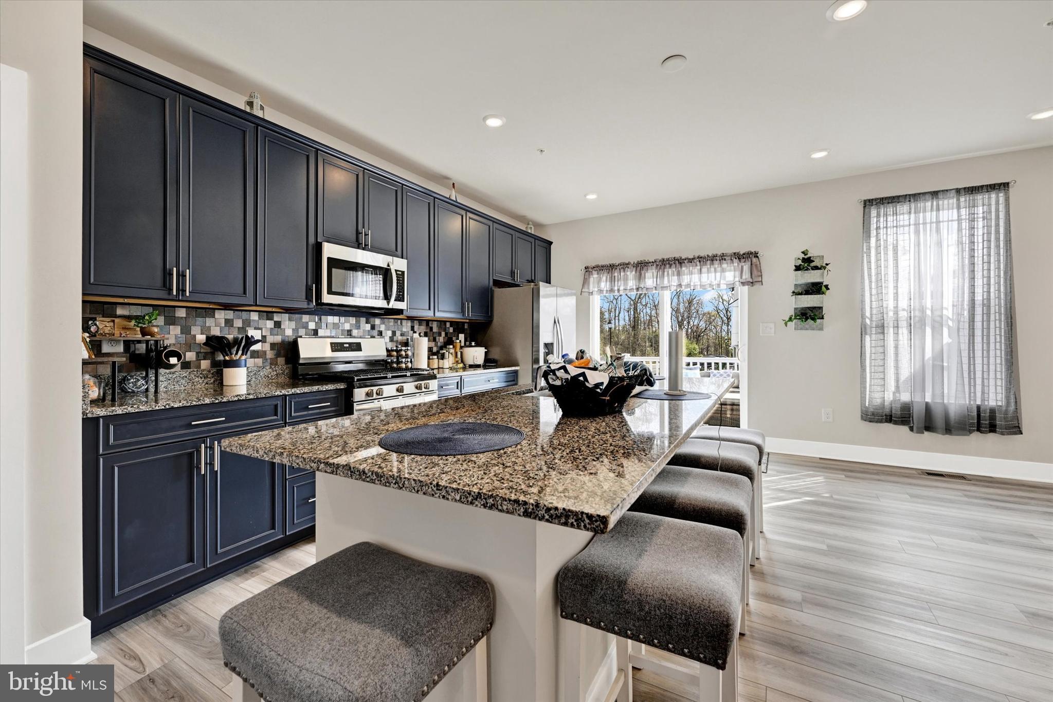 1819 Betterton Road Essex, MD 21221 - Photo 13 of 27 a kitchen with stainless steel appliances granite countertop a sink dishwasher stove refrigerator and cabinets