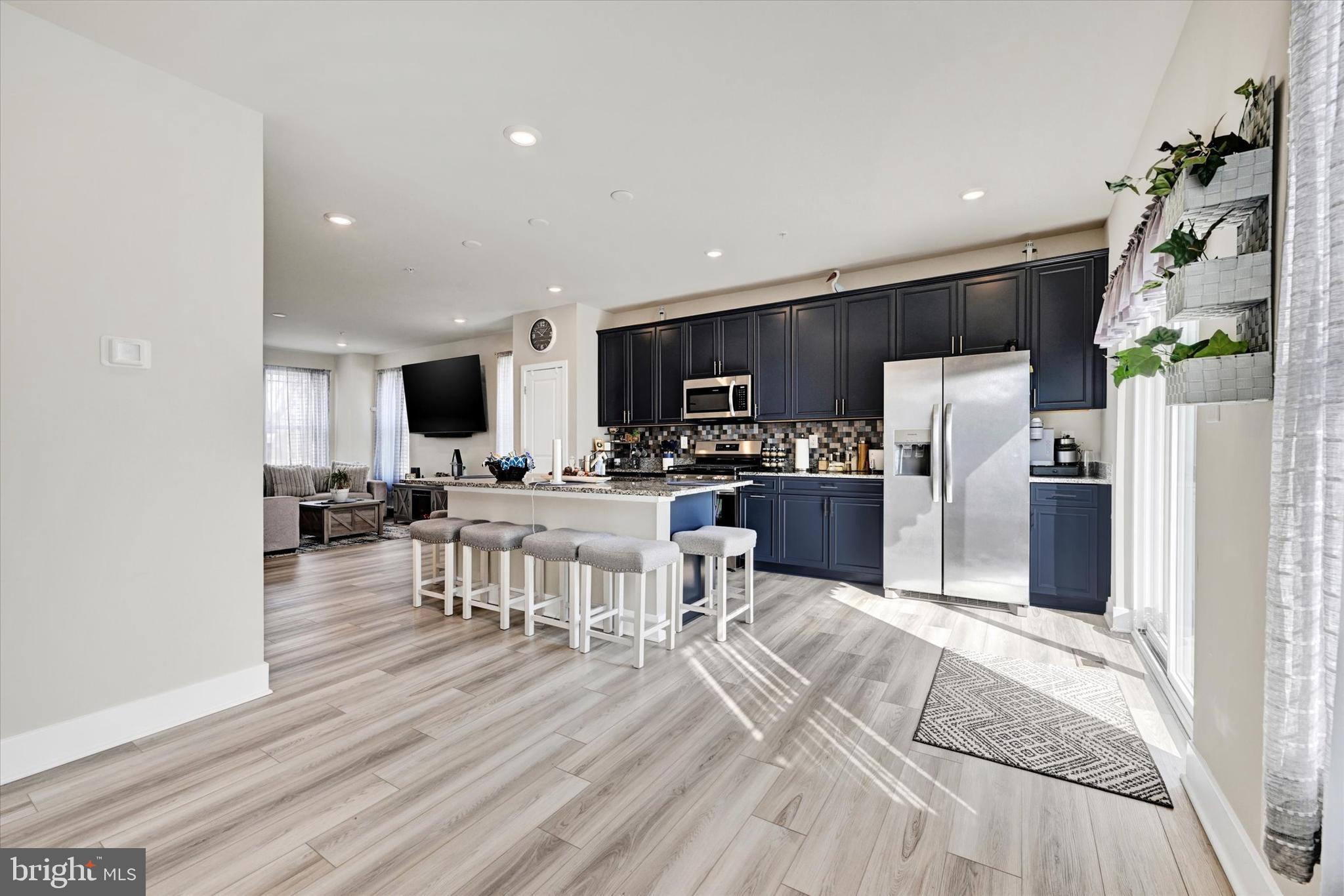 1819 Betterton Road Essex, MD 21221 - Photo 15 of 27 a kitchen with stainless steel appliances a dining table chairs microwave and sink