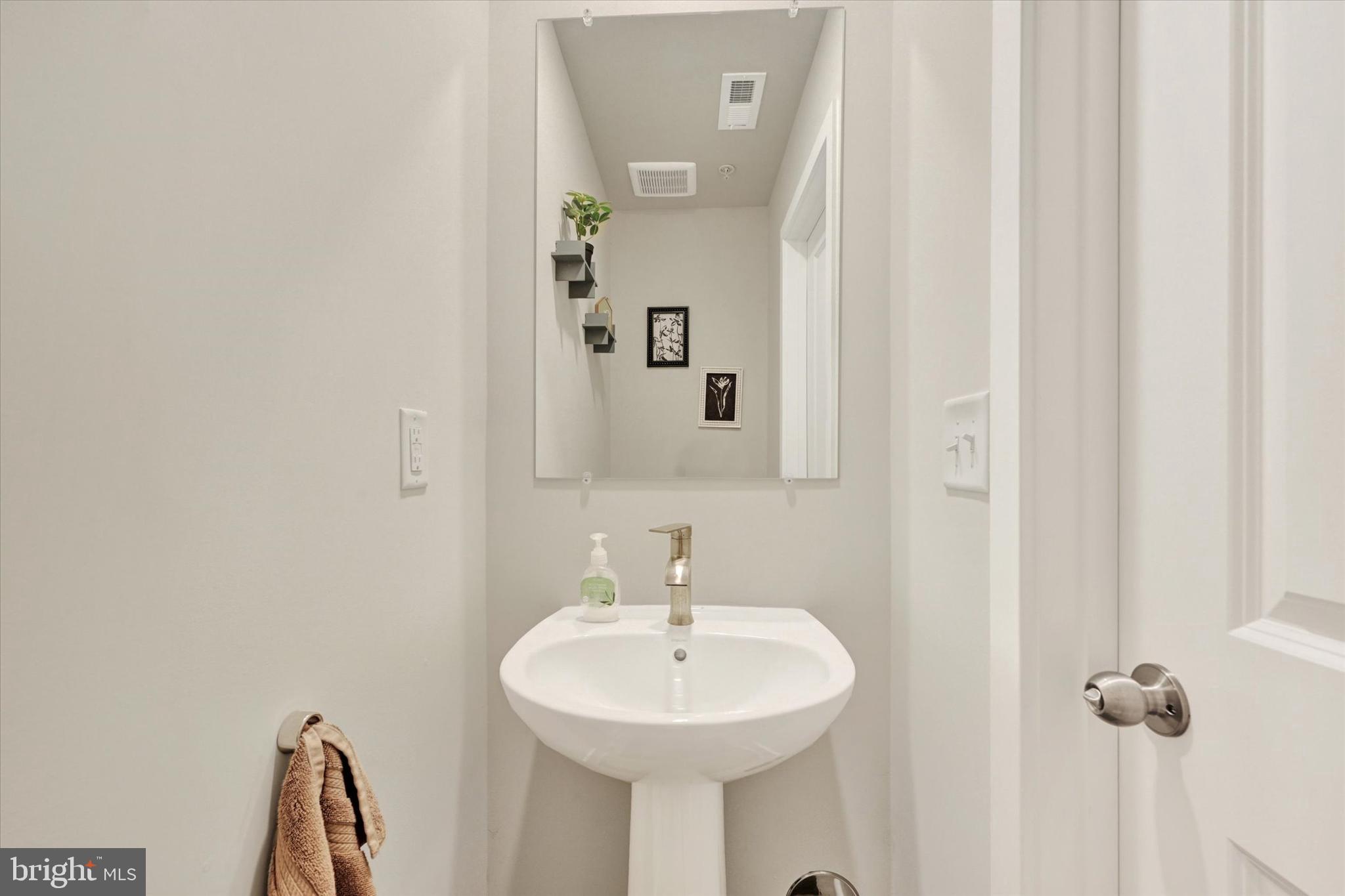 1819 Betterton Road Essex, MD 21221 - Photo 16 of 27 a bathroom with a sink and a mirror