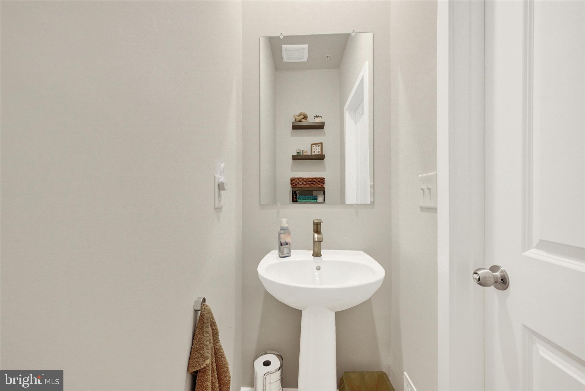 1819 Betterton Road Essex, MD 21221 - Photo 8 of 27 a bathroom with a sink and a mirror