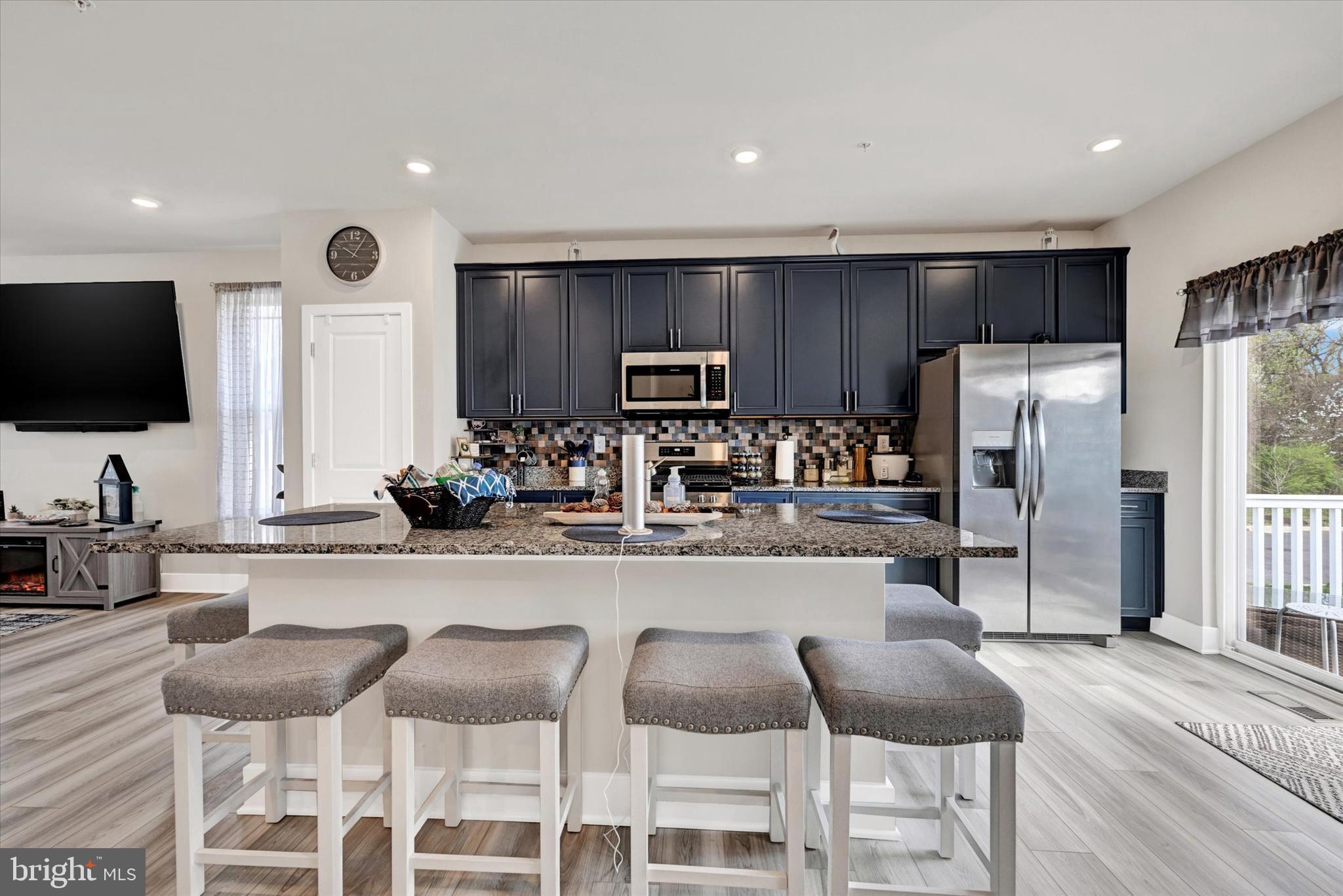 1819 Betterton Road Essex, MD 21221 - Photo 9 of 27 a kitchen with granite countertop a refrigerator and a stove top oven