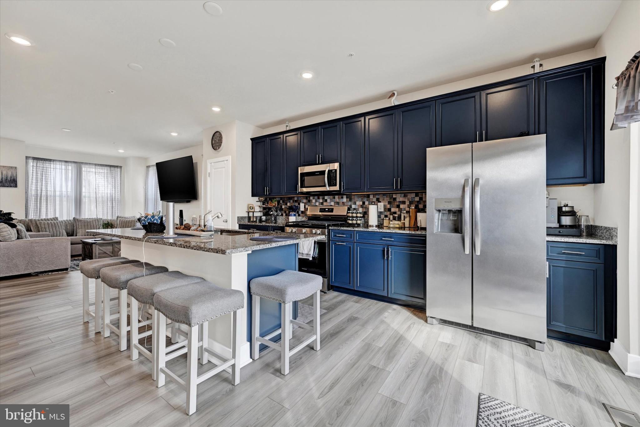 1819 Betterton Road Essex, MD 21221 - Photo 10 of 27 a large kitchen with a table chairs refrigerator and a sink